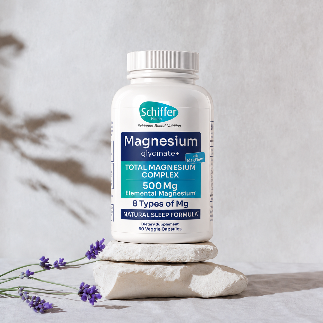 Schiffer Magnesium supplement bottle on a stone surface with lavender flowers, against a light gray background.